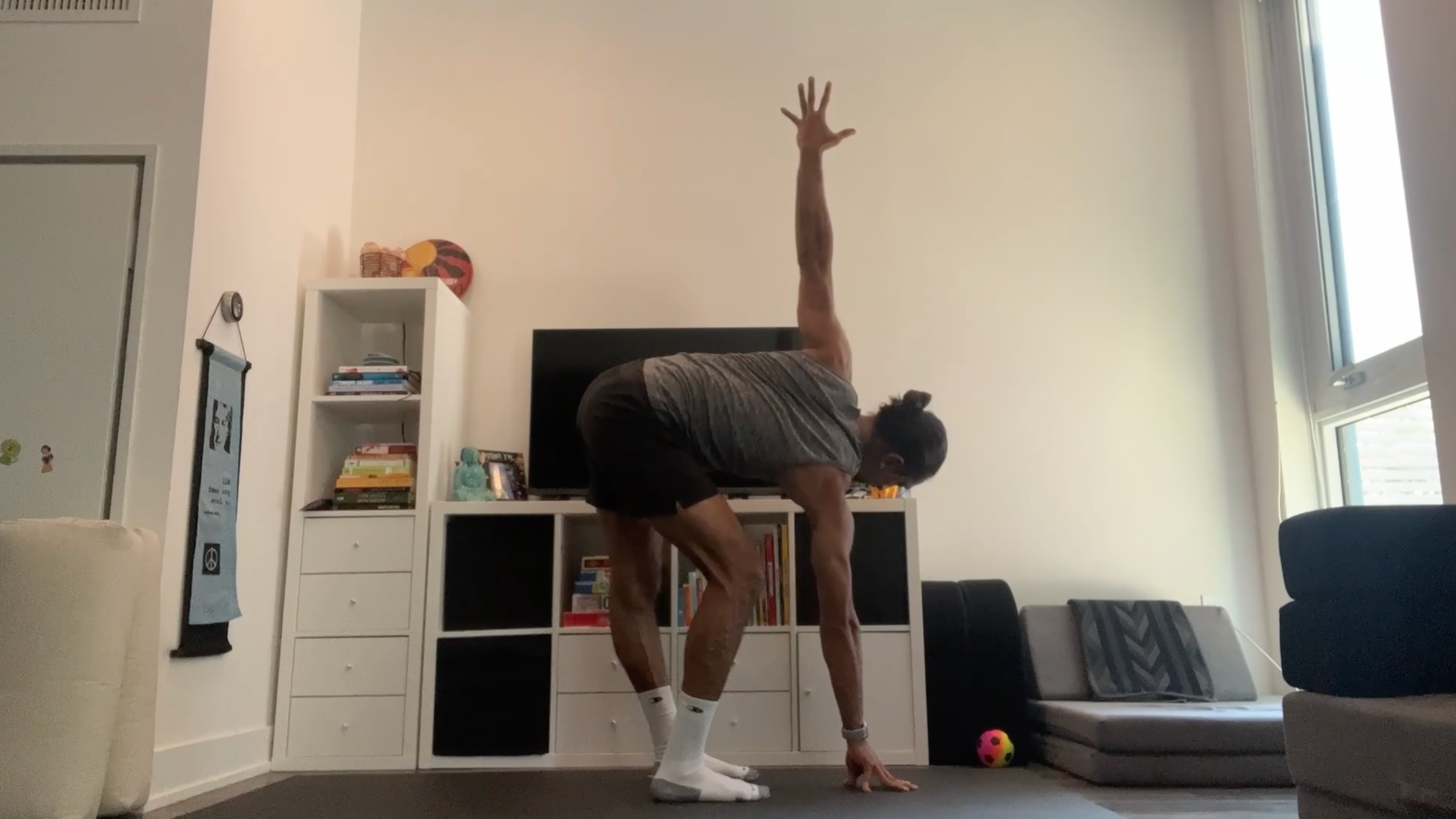 Yoga teacher Jaffer Hussain in Revolved Standing Forward Bend